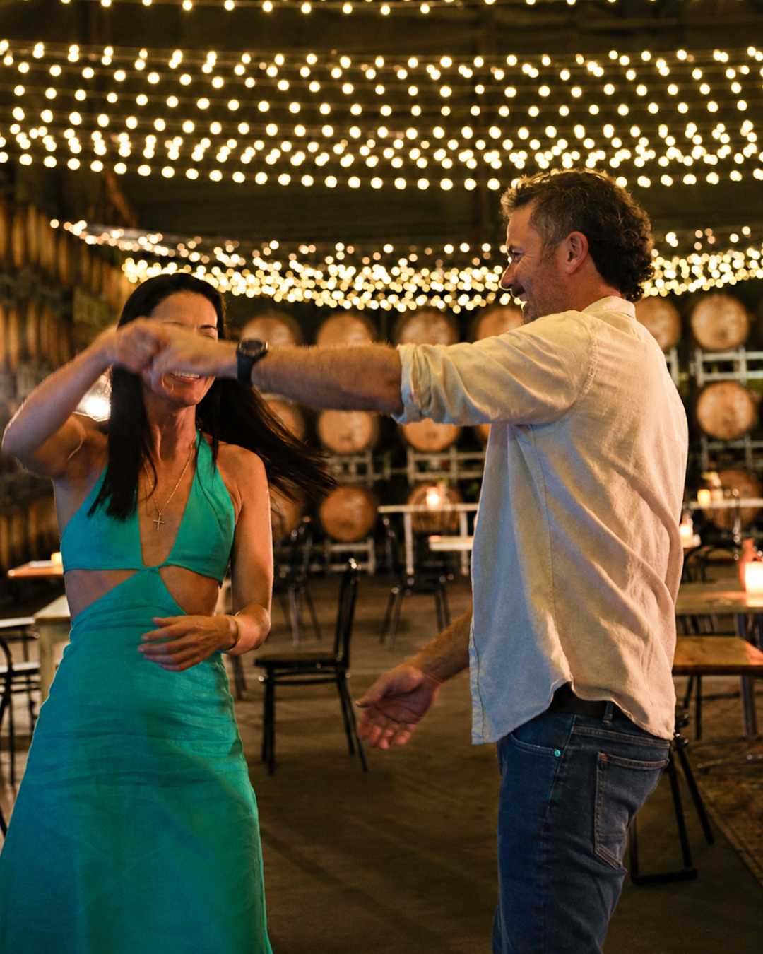 1_20260511_154411_0000 A couple dancing under fairy lights inside the historic Barrel Room private event venue at Entwine Calais Estate in the Hunter Valley.